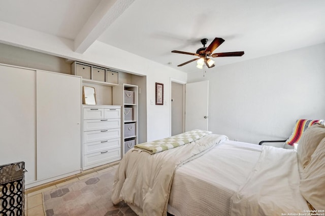 bedroom with beamed ceiling, a closet, and ceiling fan