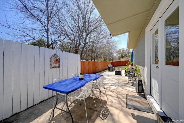 view of patio / terrace featuring outdoor dining area and a fenced backyard