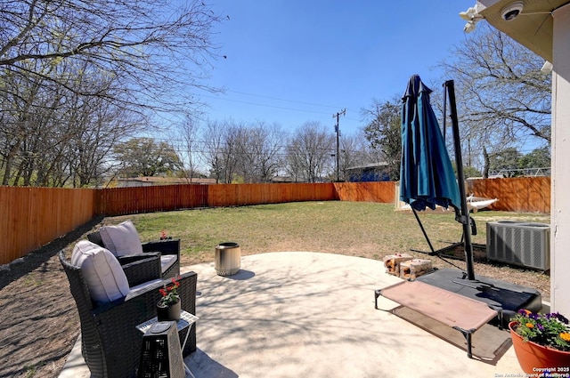 view of patio / terrace with central air condition unit and a fenced backyard