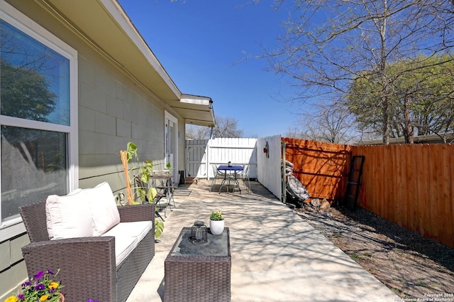 view of patio / terrace featuring an outdoor living space and a fenced backyard