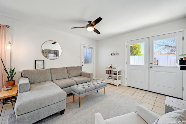 living area featuring light tile patterned floors, french doors, and ceiling fan