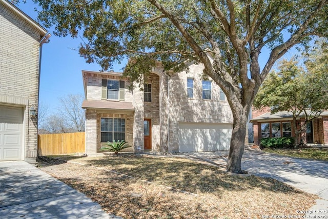 view of front of house with a garage, fence, brick siding, and driveway