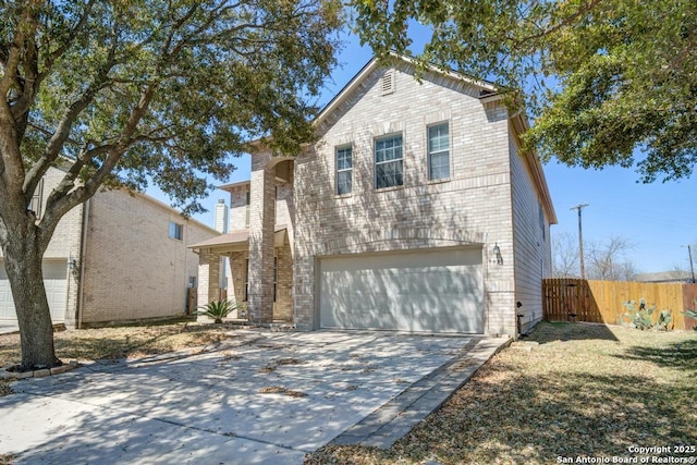 traditional-style house with a gate, fence, concrete driveway, an attached garage, and brick siding