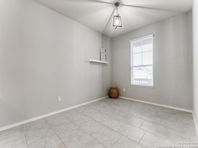 unfurnished room featuring baseboards