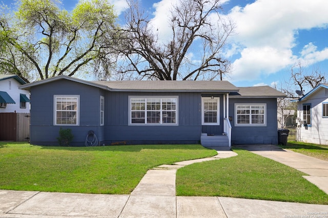 single story home featuring a front yard, fence, and driveway