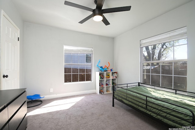 bedroom with baseboards, a ceiling fan, and carpet flooring