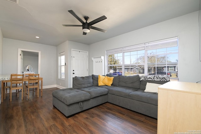 living room with a ceiling fan, dark wood-style floors, and baseboards