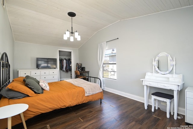 bedroom featuring dark wood-style floors, a closet, an inviting chandelier, baseboards, and vaulted ceiling