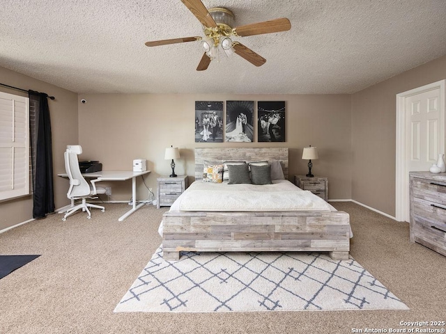 carpeted bedroom with baseboards, a textured ceiling, and a ceiling fan