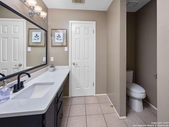 bathroom featuring vanity, tile patterned floors, toilet, and visible vents