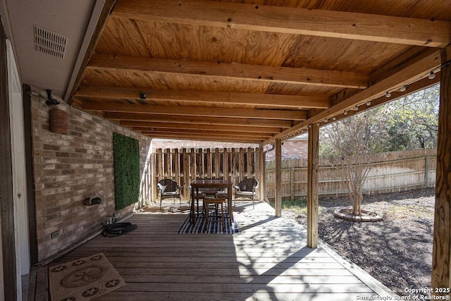 wooden deck with visible vents, outdoor dining space, and fence