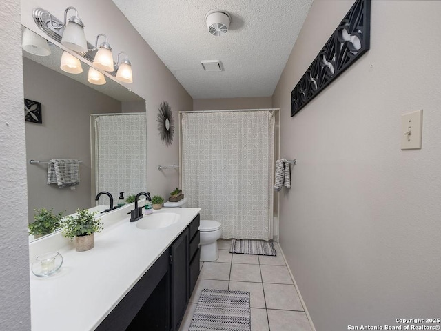 full bathroom featuring tile patterned floors, a shower with curtain, toilet, a textured ceiling, and vanity