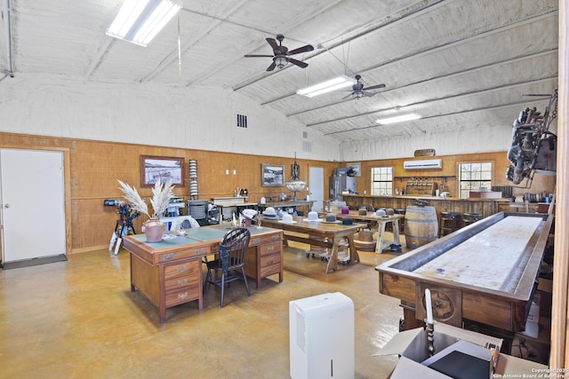 interior space with a wall mounted air conditioner, high vaulted ceiling, concrete floors, and a ceiling fan