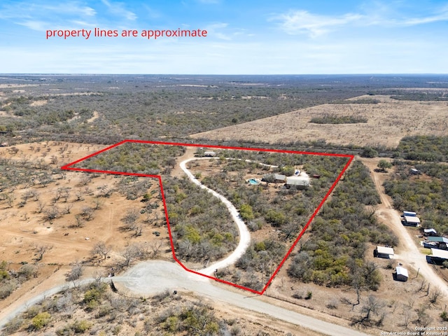 drone / aerial view featuring a desert view and a rural view