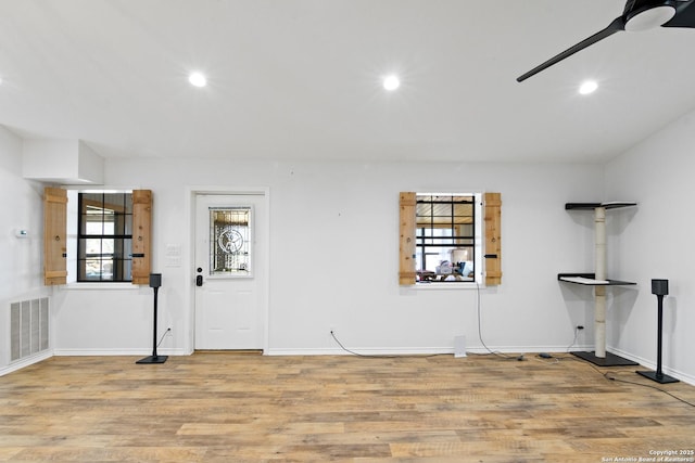 interior space featuring wood finished floors, baseboards, visible vents, recessed lighting, and ceiling fan