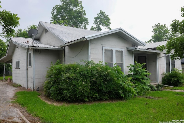 view of side of property featuring metal roof