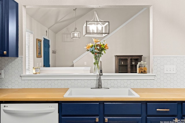 interior space featuring butcher block countertops, blue cabinetry, a sink, and white dishwasher