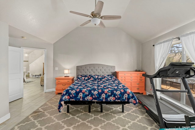 bedroom featuring baseboards, lofted ceiling, a ceiling fan, and wood tiled floor