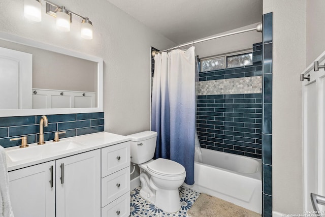 full bathroom featuring shower / bath combo with shower curtain, toilet, tile patterned flooring, decorative backsplash, and vanity