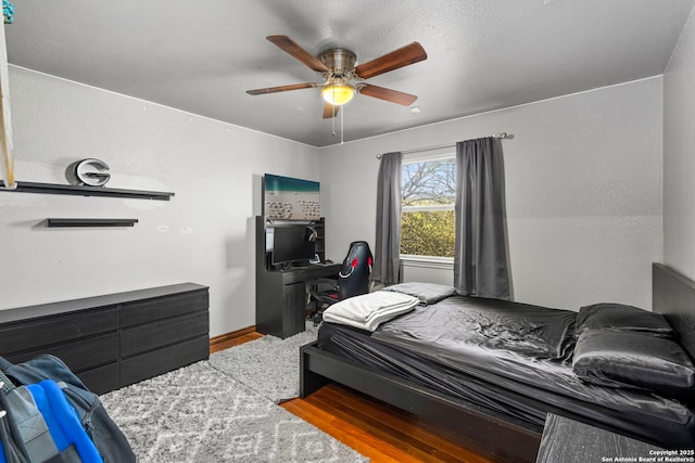 bedroom featuring ceiling fan and wood finished floors