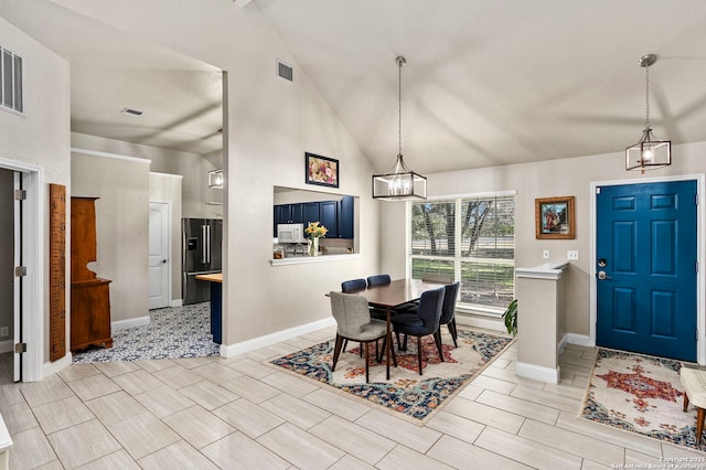 dining area featuring a chandelier, visible vents, high vaulted ceiling, and baseboards