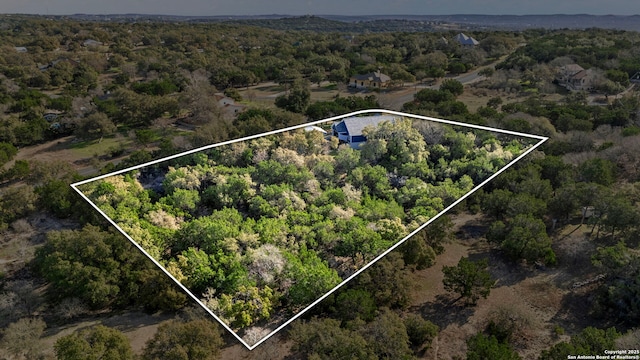 drone / aerial view featuring a forest view