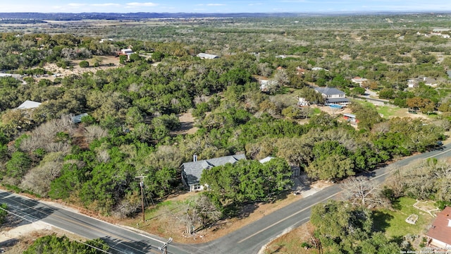 drone / aerial view with a wooded view