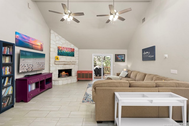 living area featuring visible vents, high vaulted ceiling, a stone fireplace, and ceiling fan