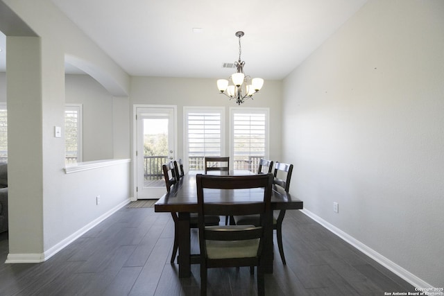 dining room with visible vents, baseboards, dark wood finished floors, and a chandelier