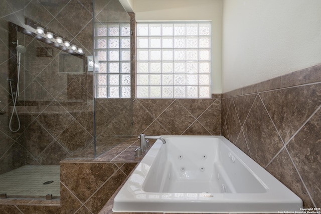 full bath featuring a wealth of natural light, a whirlpool tub, and a tile shower