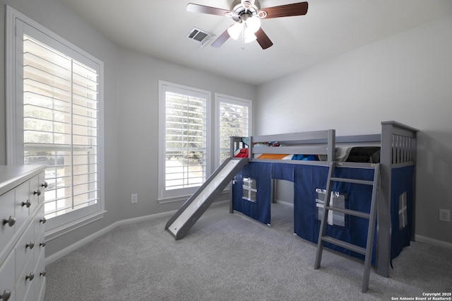 carpeted bedroom with visible vents, ceiling fan, and baseboards