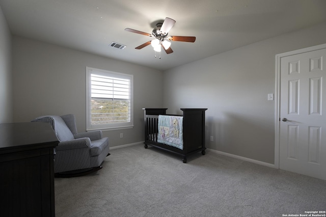 bedroom with visible vents, light carpet, baseboards, and ceiling fan