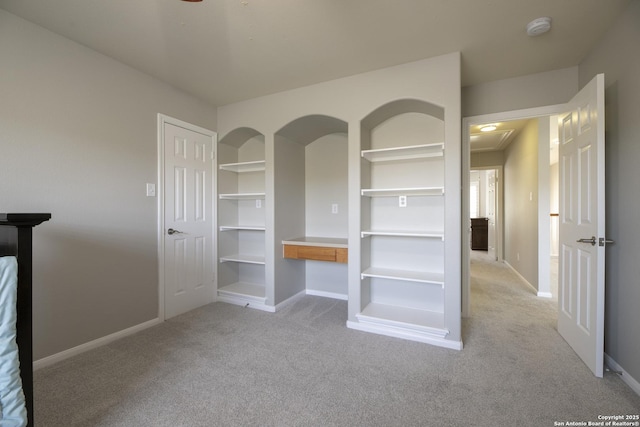 unfurnished bedroom with light colored carpet and baseboards