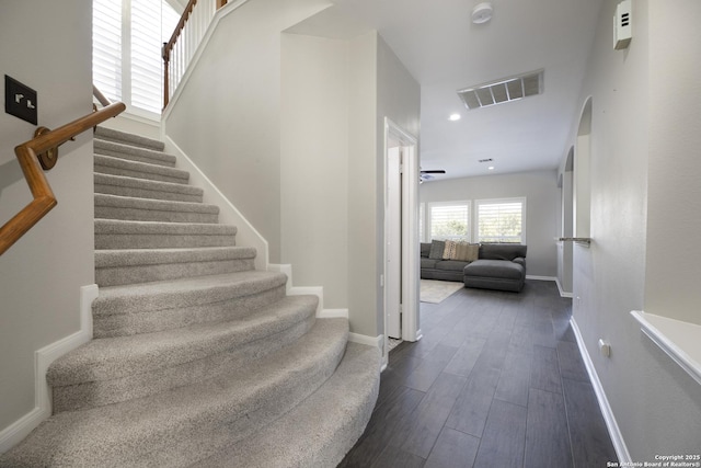 stairs with visible vents, recessed lighting, baseboards, and wood finished floors