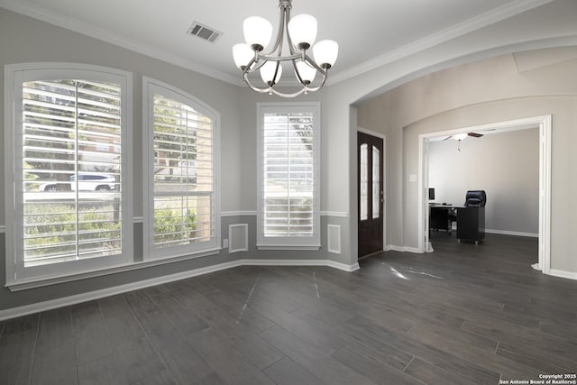 unfurnished dining area featuring dark wood-type flooring, crown molding, arched walkways, and visible vents