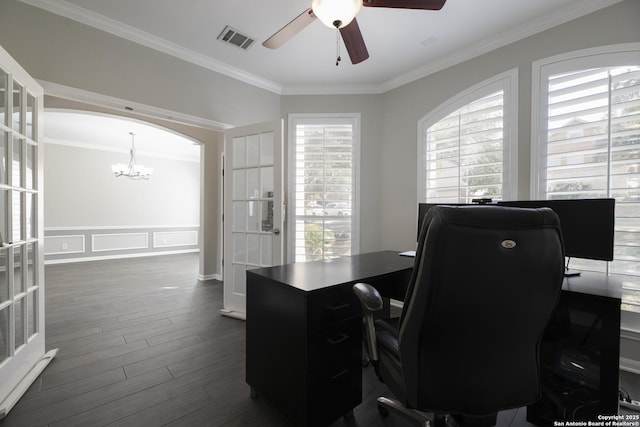 office area featuring visible vents, dark wood finished floors, ornamental molding, ceiling fan with notable chandelier, and arched walkways