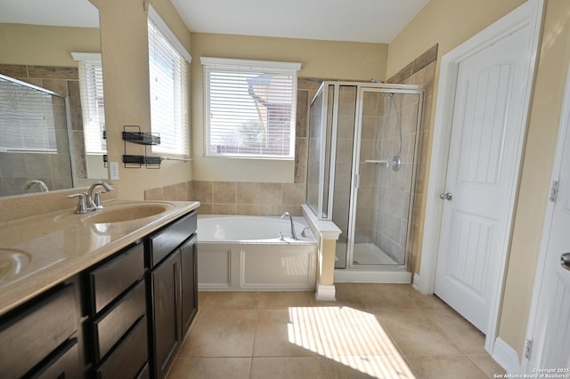 full bathroom with double vanity, a sink, tile patterned flooring, a shower stall, and a bath