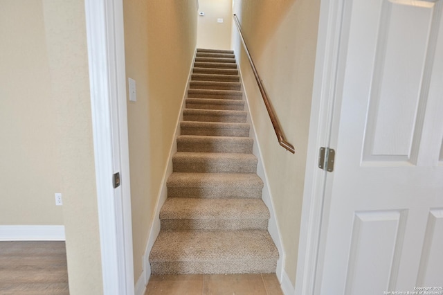 staircase featuring baseboards