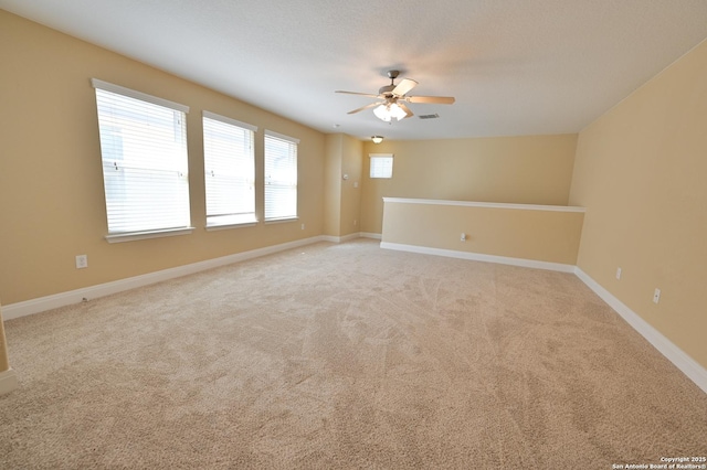 unfurnished room with visible vents, a ceiling fan, baseboards, and carpet floors