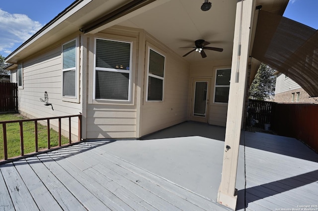 deck featuring ceiling fan and fence