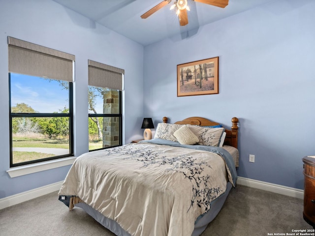 carpeted bedroom with a ceiling fan and baseboards