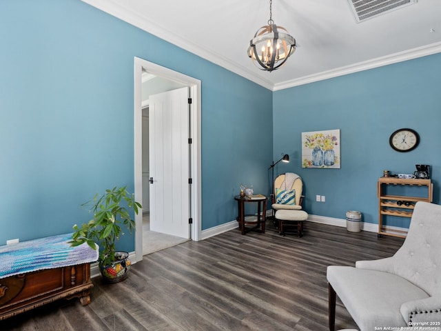 living area featuring visible vents, baseboards, wood finished floors, and crown molding