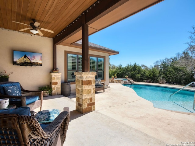 view of swimming pool with a patio area, a pool with connected hot tub, and ceiling fan