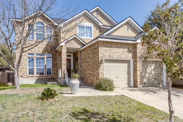 view of front facade featuring a garage, brick siding, driveway, and stucco siding