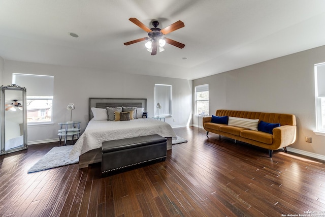 bedroom featuring hardwood / wood-style flooring, a ceiling fan, and baseboards