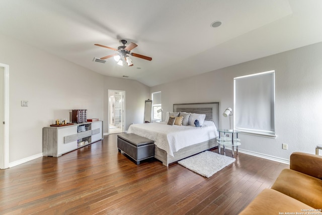 bedroom with wood finished floors, visible vents, baseboards, ceiling fan, and vaulted ceiling