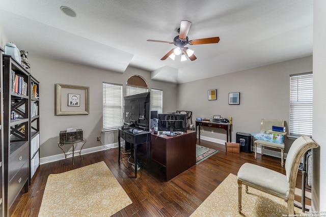 office featuring a ceiling fan, baseboards, and wood-type flooring