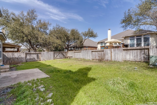 view of yard featuring a patio area and a fenced backyard