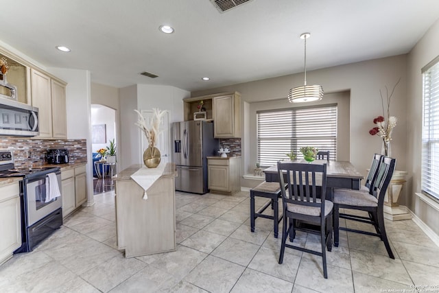 kitchen featuring a kitchen island, open shelves, arched walkways, light brown cabinetry, and stainless steel appliances