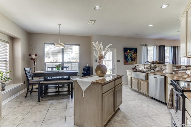 kitchen with a sink, a healthy amount of sunlight, visible vents, and stainless steel appliances